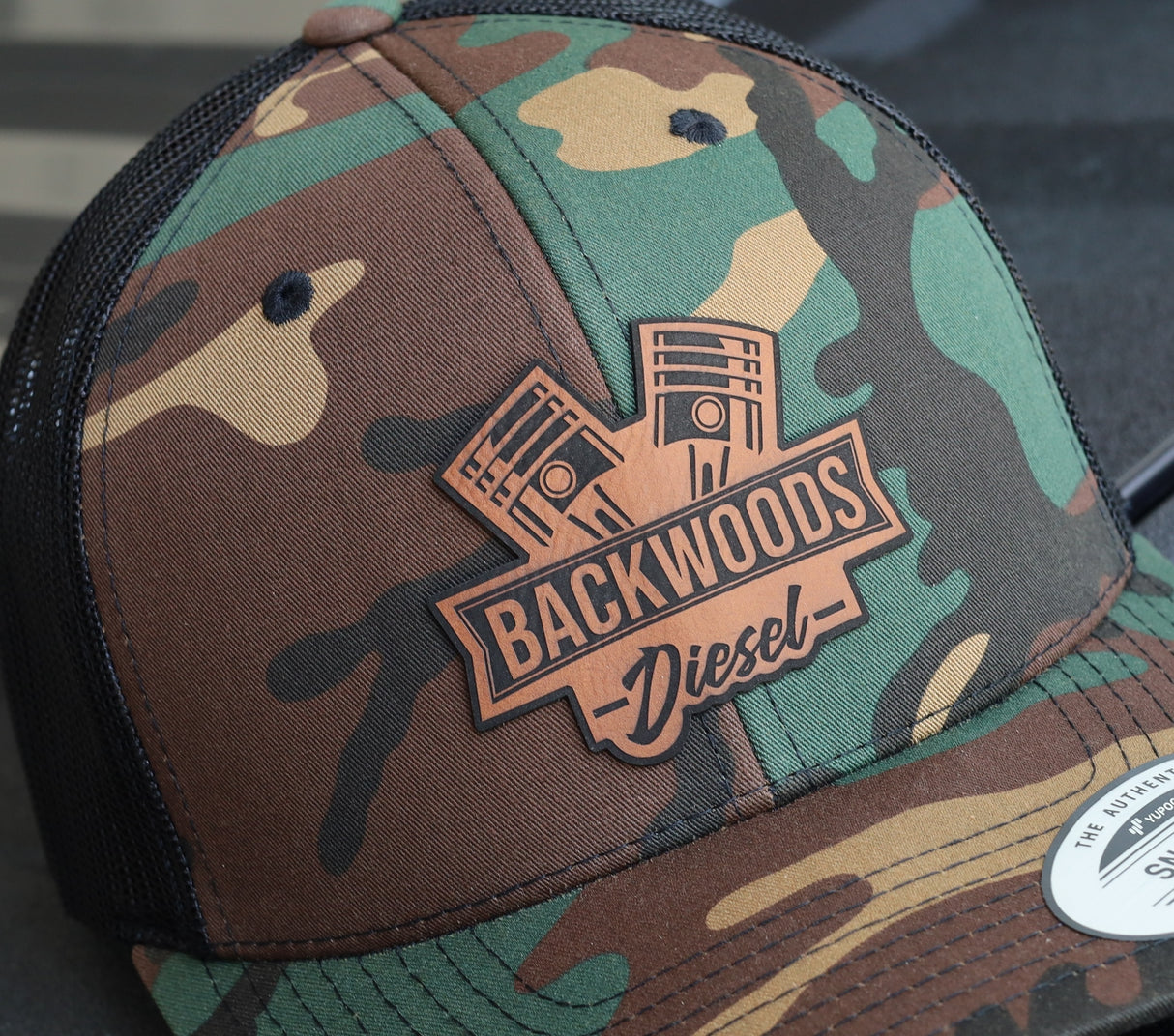 BackWoods Diesel Trucker Hat – Camo & Black Snapback with Leather Patch